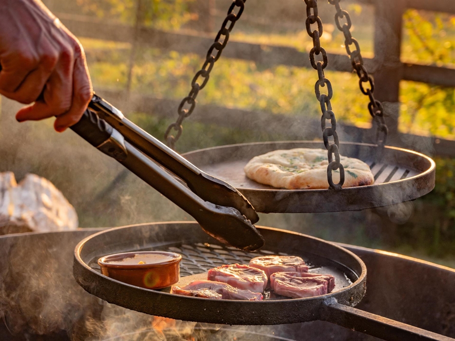 Outdoor fire pit with cooking facilities, two recliners and small table - BBQ utensils and pot / pan provided