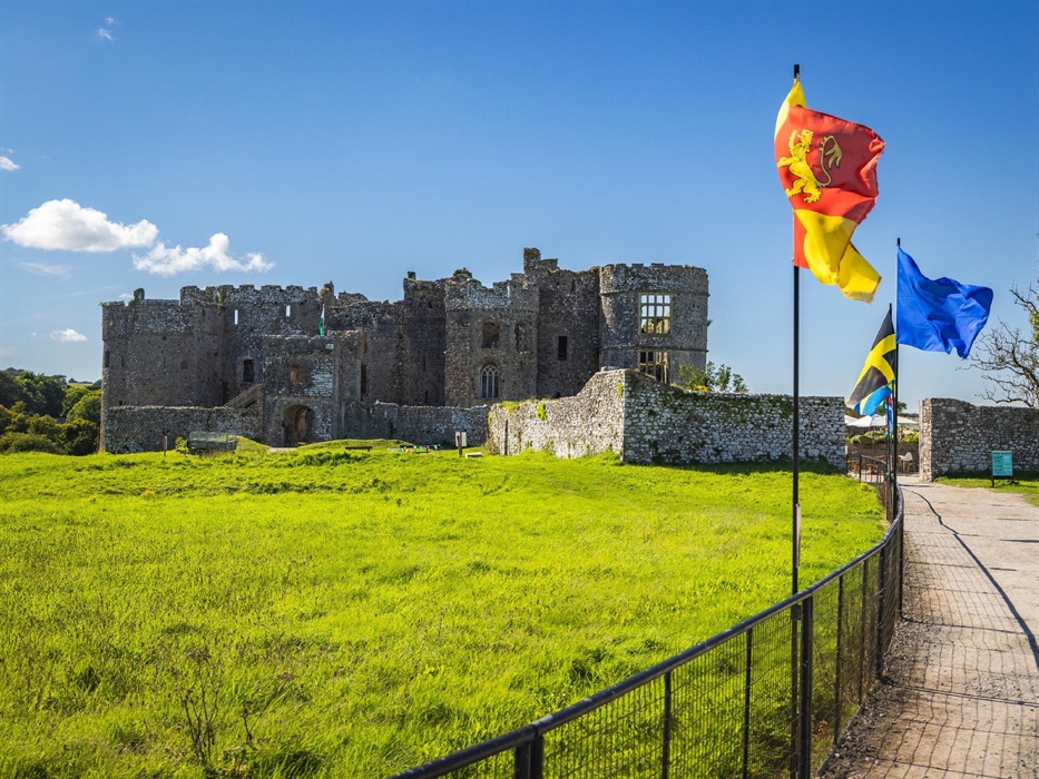 Carew Castle at another angle and showing the range of flags flying.