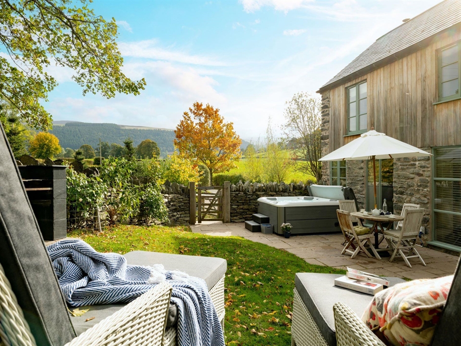 Sit down, take the weight off and enjoy views for miles whist listening to your hot tub bubbling away in the background .