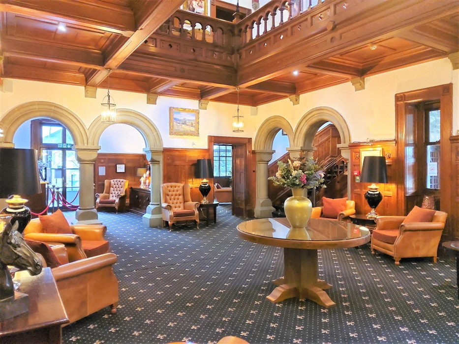 Open lounge with minstrels gallery. Reception doors lead on to the patio and terrace