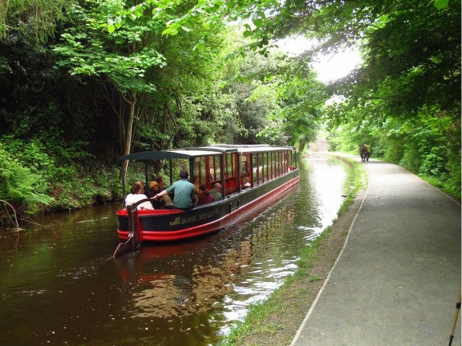 A scenic view of Llagollen Wharf's horse drawn boats as it glides gently through the water.