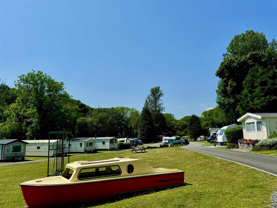 Here is our small play area with swings and a slide along with the ever popular boat!