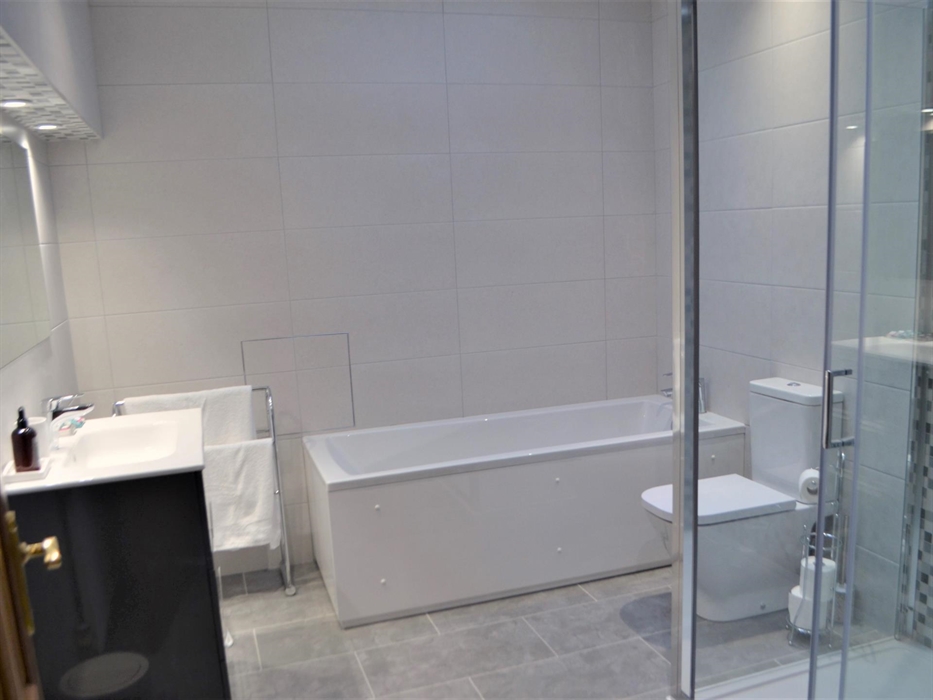 Bathroom with white bath, toilet, shower and sink