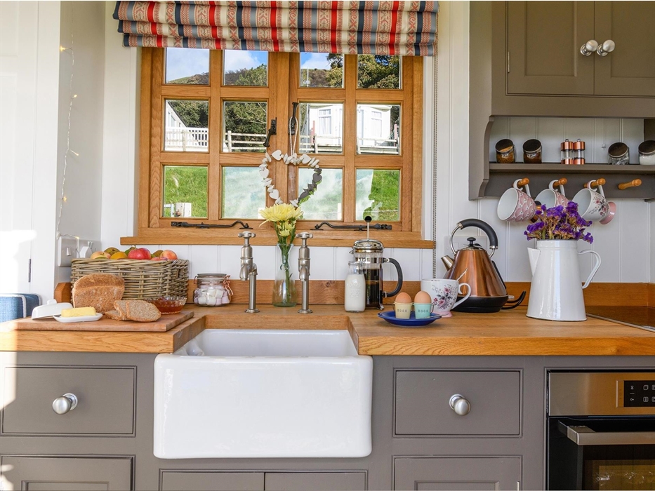 The kitchen area is cleverly designed and well equipped.  It features a Bosch hob and oven/microwave.  It also has an extractor fan and a concealed sm