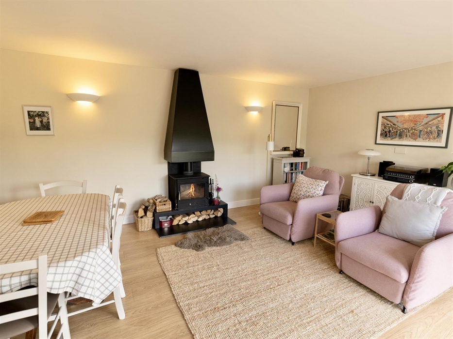 Dining room with log burner and recliners