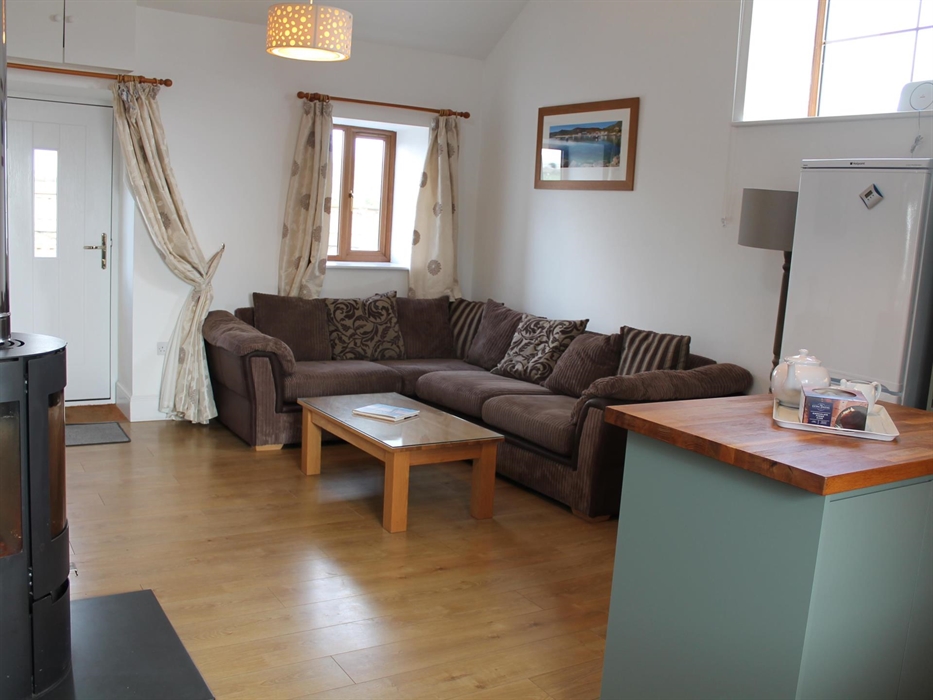 Spacious lounge with comfy sofa, wood burning stove & HD smart TV