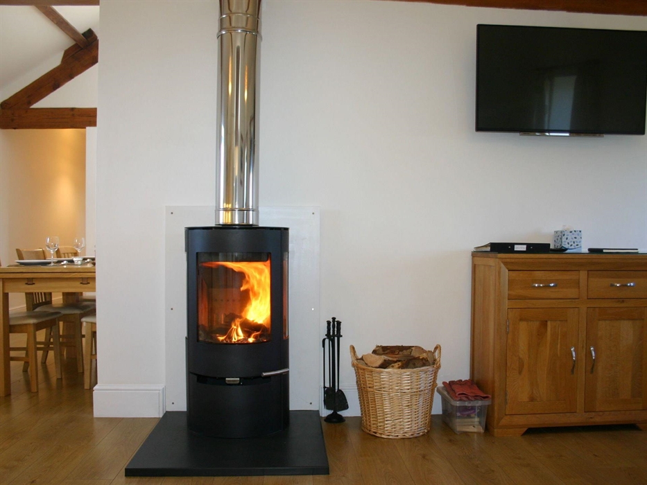 Lounge area with wood burning stove & HD smart TV