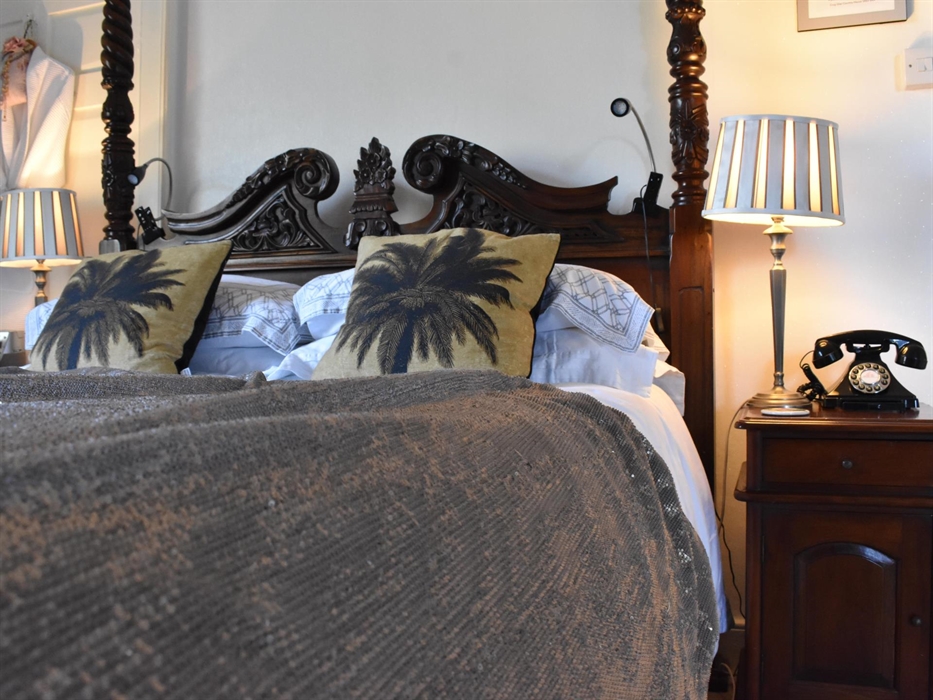 A large, luxurious room with a double aspect overlooking beautiful open countryside.The centrepiece is a king-size four-poster bed. And the indulgence