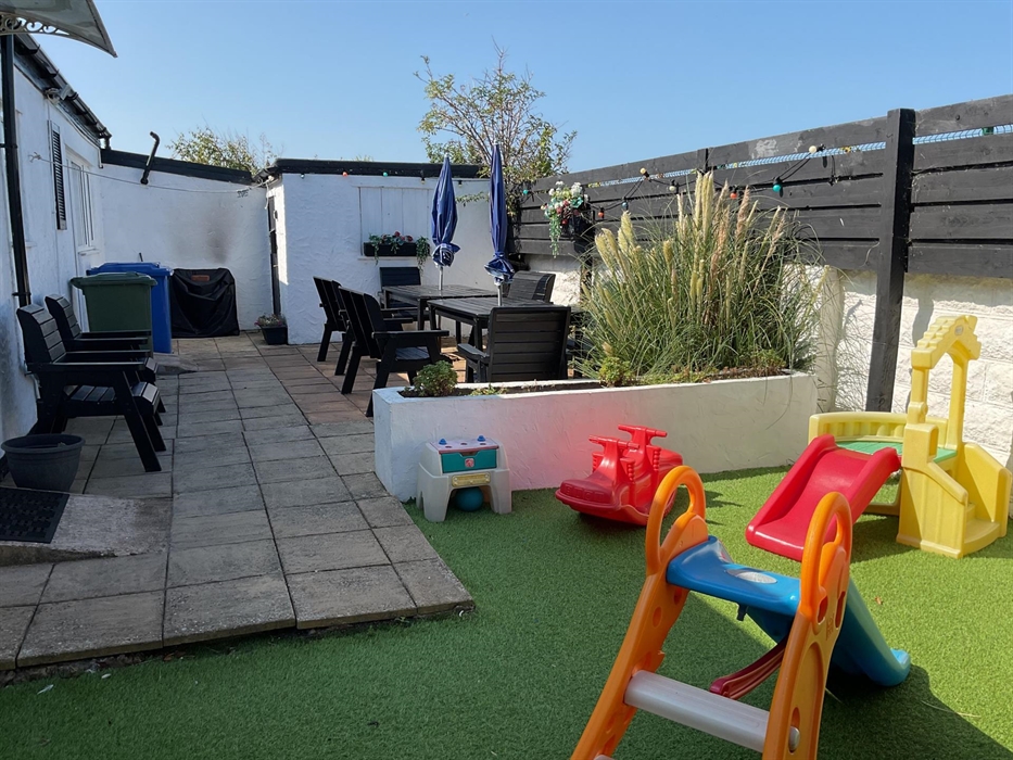 Secure rear garden with patio furniture