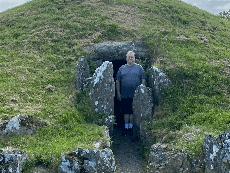 Peter emerges from the interior of Bryn Celli Ddu.