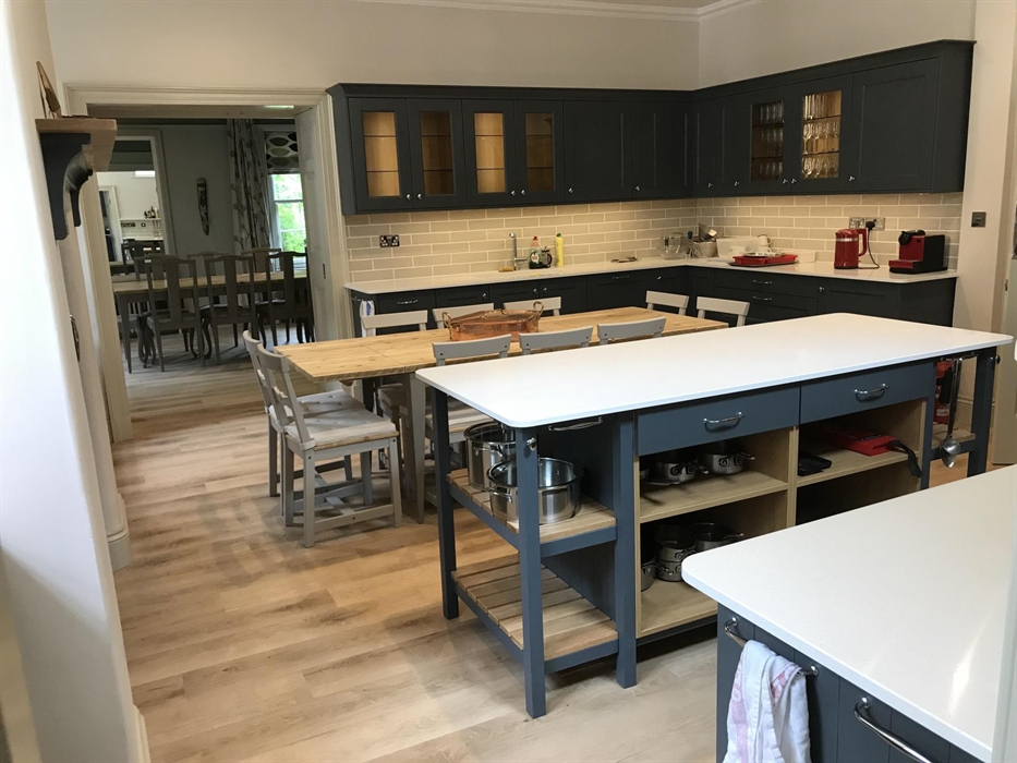 The spacious kitchen leads into the lovely dining room, which can be closed off using the shutter doors