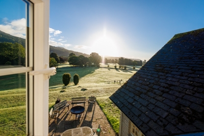 view from the window of The Glanusk Lodge at sunrise with beautiful blue skies