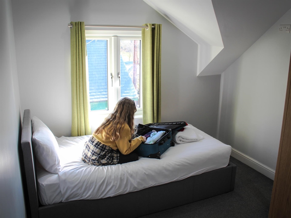 Single bed at Glandwr House, Rhayader with a double bed above on a mezzanine