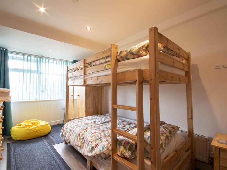 Welsh Row House Adult Bunk Beds. Bedside cabinets and lamp. Wardrobe and laminate floor.   Room sleeps up to four.  Sega Mini Mega Drive and Games.