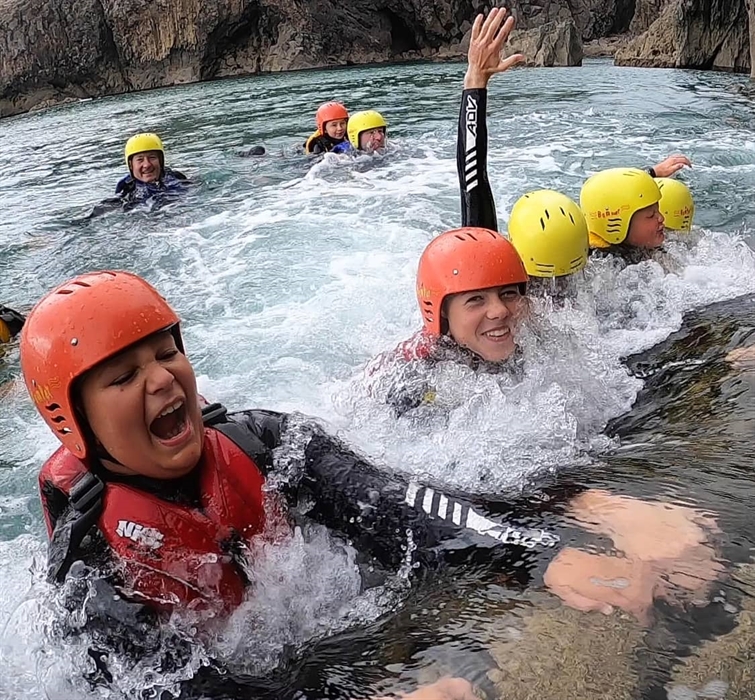Young coasteerers enjoying the waves