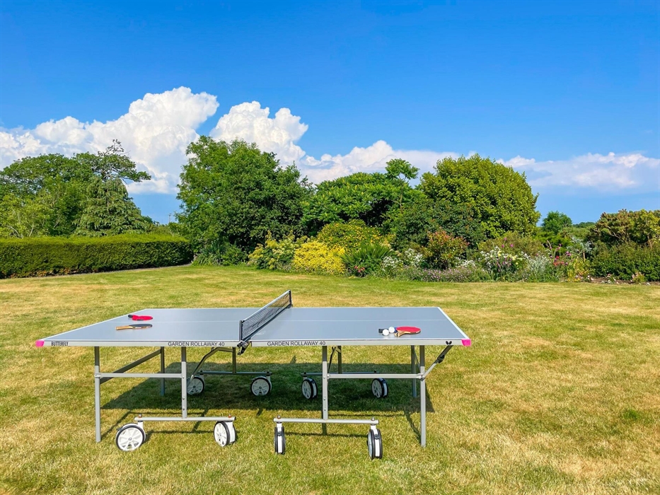 The lawn at Ysgubor Degwm Holiday Let self catering in North Wales between Criccieth and pwllheli with a butterfly garden rollaway table tennis table.