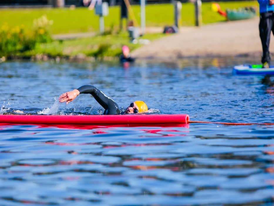 Swimmers in the lake at Parc Bryn Bach.