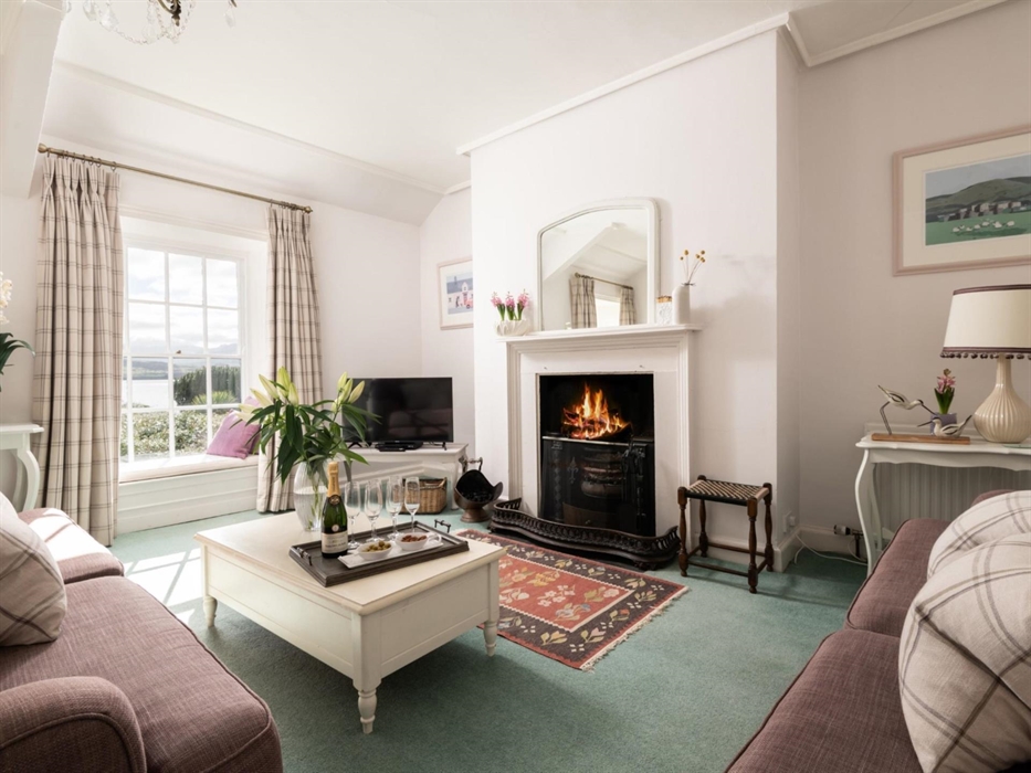 A large upstairs sitting room that seats six comfortably and benefits from two window seats to enjoy the sea and mountain views from.