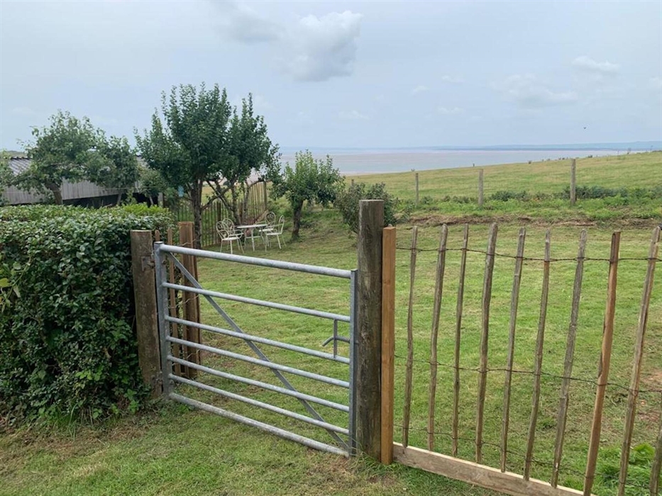 Side entrance to rear garden showing view of the local beach