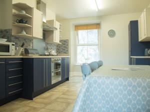 Connected to the lounge through an open archway, the kitchen is well equipped with a dishwasher, fridge freezer, gas hob and electric oven.