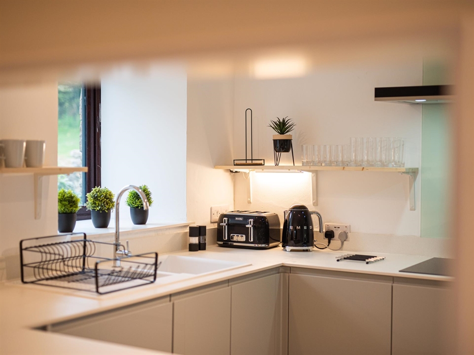 Discover a well-equipped kitchen, where modern amenities meet rustic charm, ready to facilitate delightful home-cooked meals during your stay.