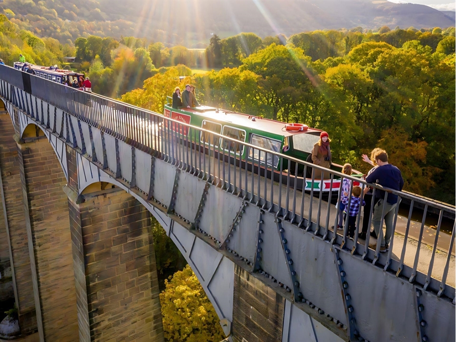 An aerial view of motorised canal boats crossing the iconic Pontcysyllte Aqueduct.