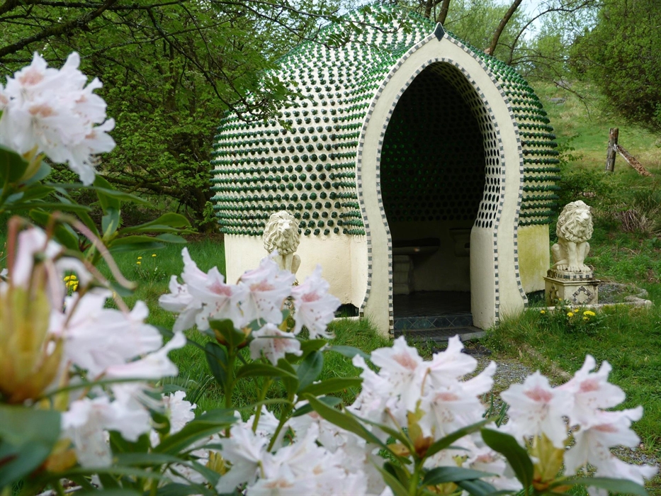 A temple, constructed out of over 2,500 dumpy bottles, creating beautiful light and acoustics. It is flanked by concrete lions, and a rhododendron in