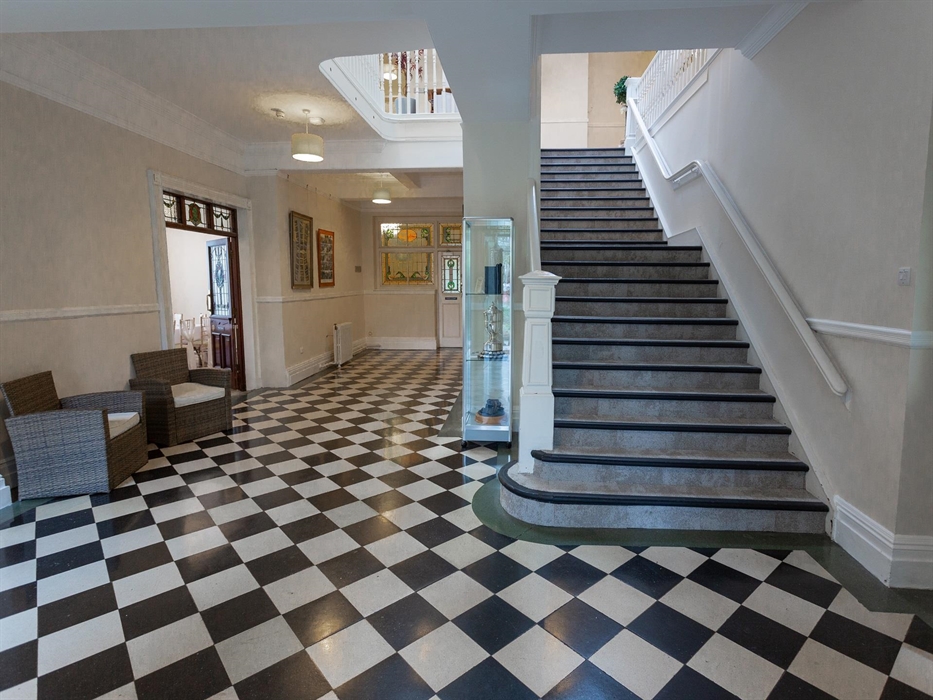 A shot of the hallway and impressive staircase.
