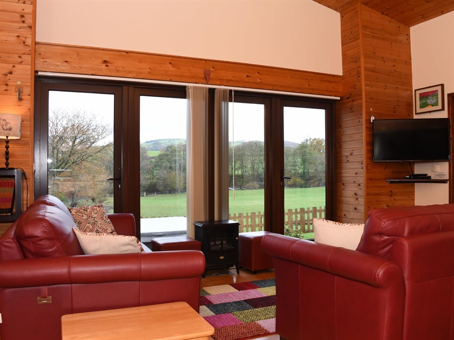Lounge area with smart TV and a view across the countryside.