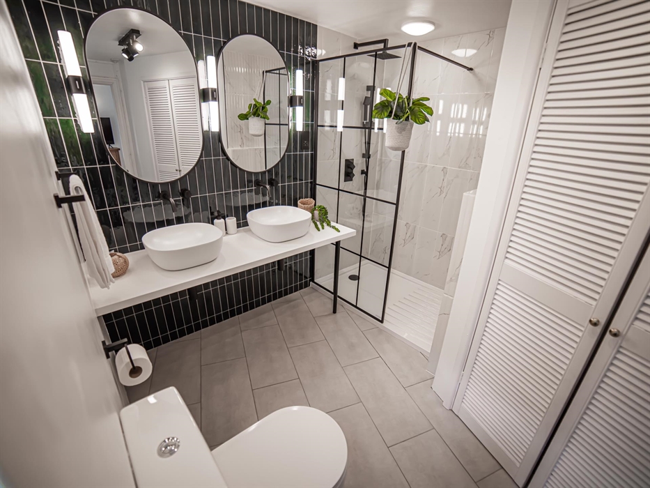 Step into the expansive walk-in shower for a refreshing start to your day, designed for ease and accessibility.