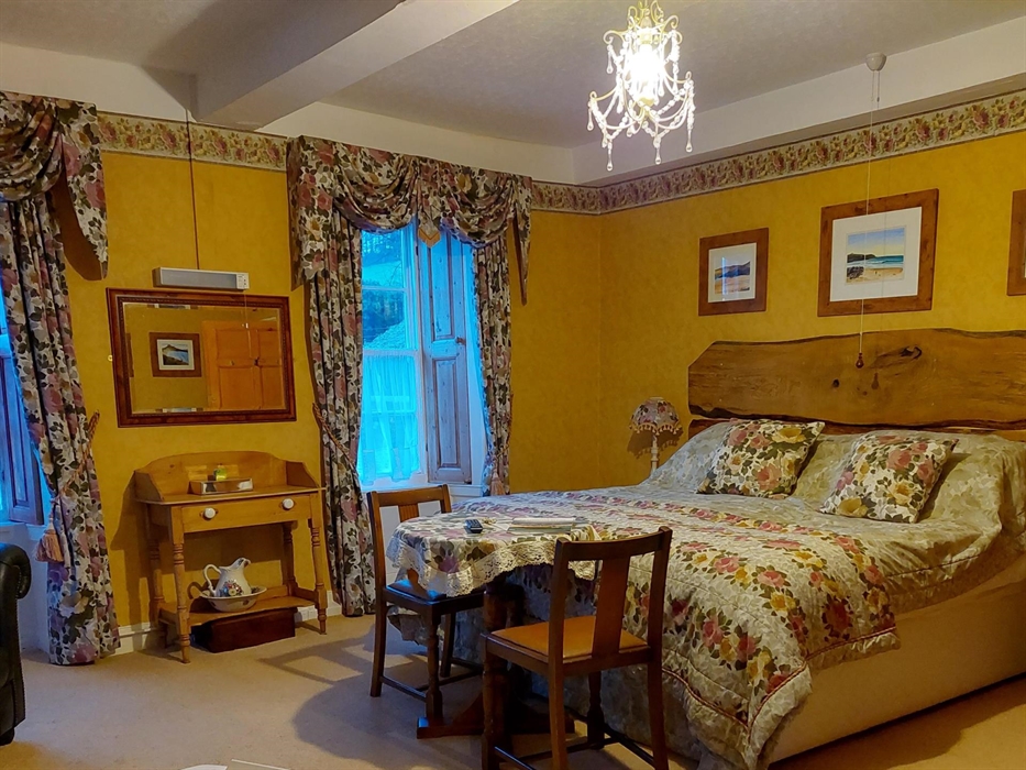 Morning sun shine and bird song welcome in the day to the master room .