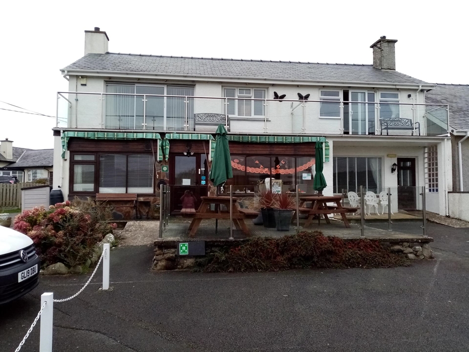The self catering apartment with its balcony is upstairs on the left of the picture