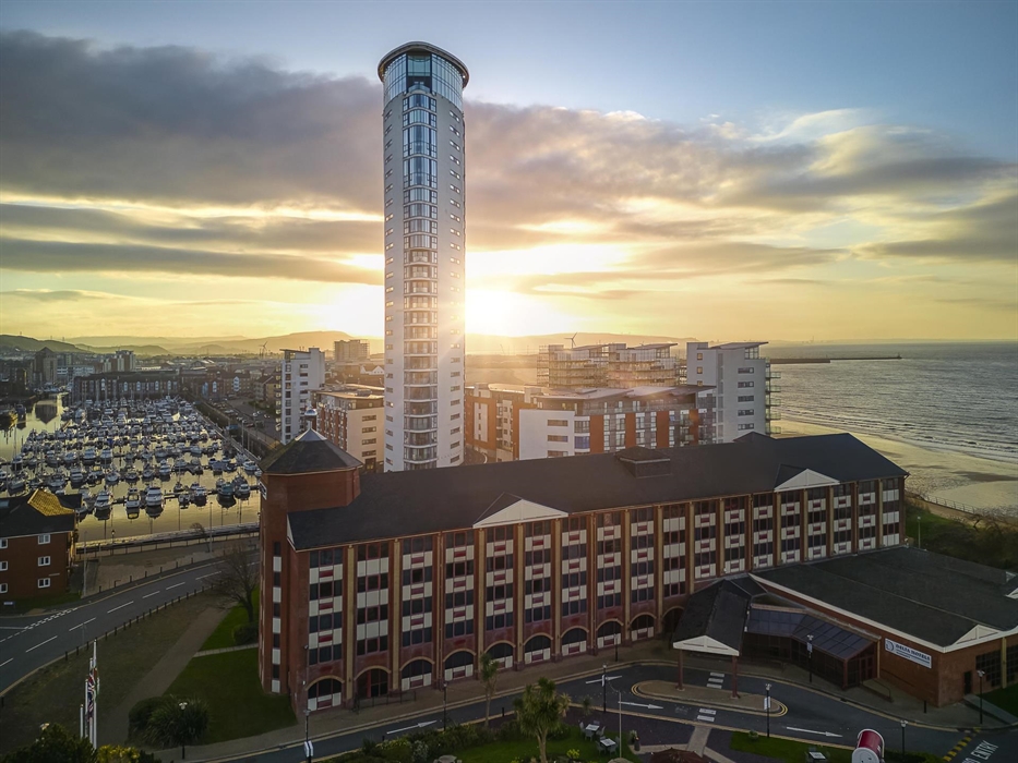 A beautiful scene & exterior shot of Delta Hotels by Marriott Swansea with the marina and sea views.
