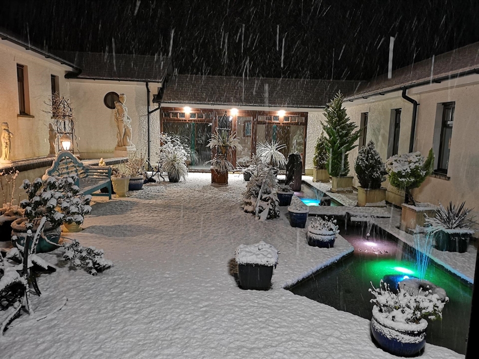 Snow in the courtyard; inner pond with coloured lights, all other lights on