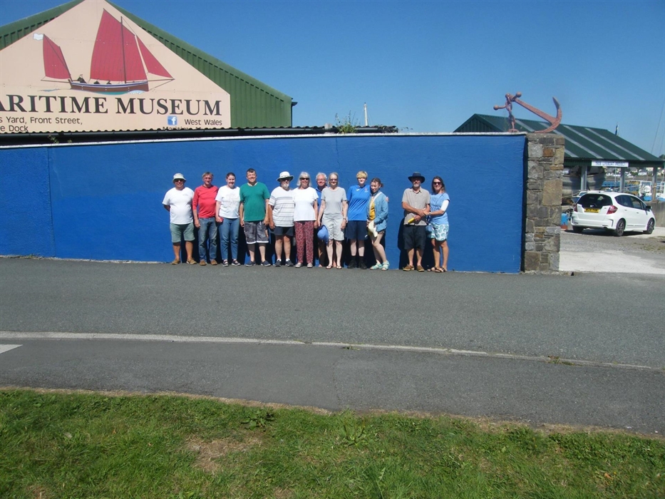 Happy visitors pose outside our entrance