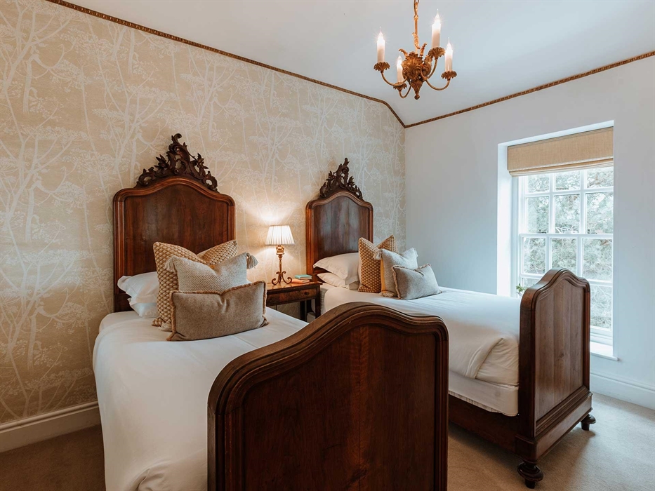 Bedroom Three is a first floor twin room looking over the terrace towards the river and the Breidden Hills in the distance.