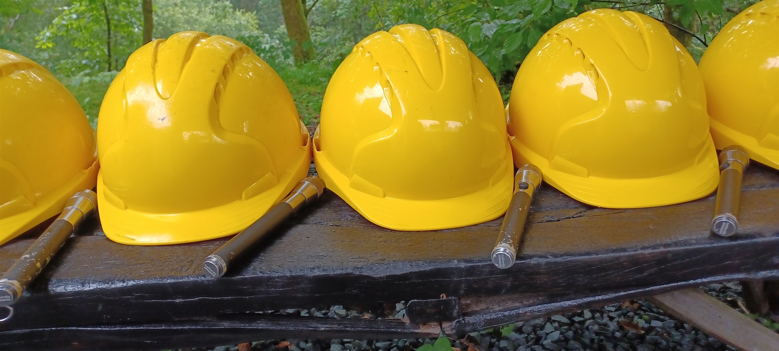 Yellow hard helmets and hand torches