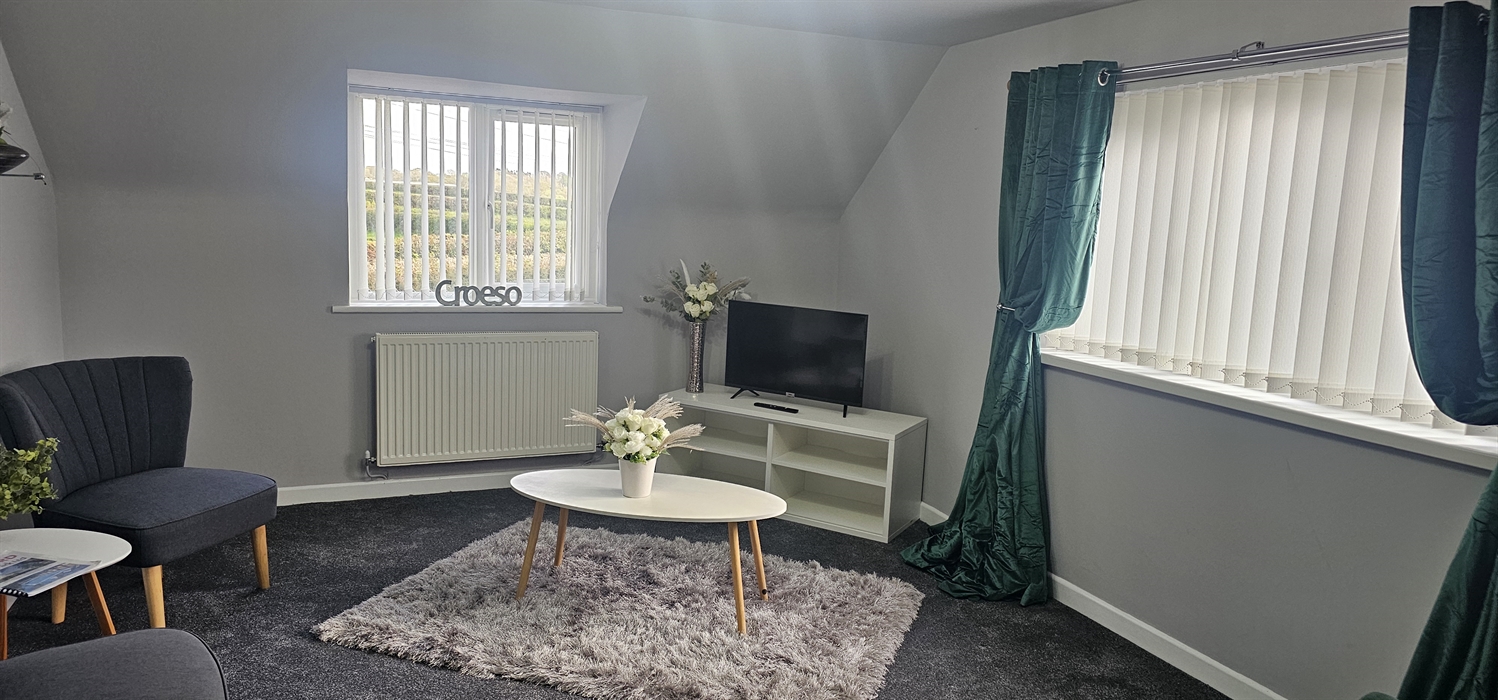 The Redford Cwtch Lounge – a cosy, welcoming space with soft seating, warm lighting, and rustic charm, perfect for relaxing with family or friends aft