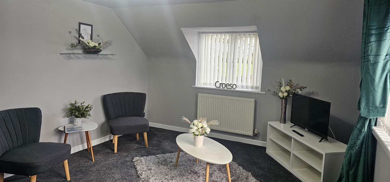 The Redford Cwtch Lounge – a cosy, welcoming space with soft seating, warm lighting, and rustic charm, perfect for relaxing with family or friends aft