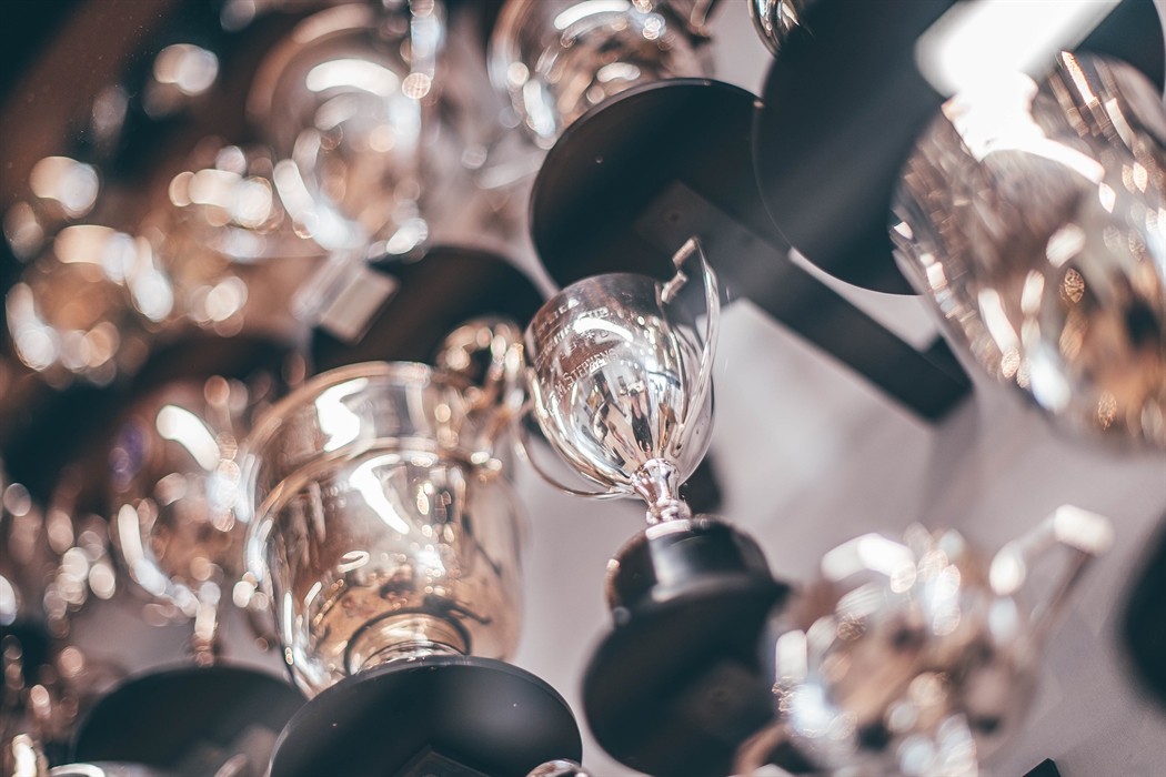 Selection of silver trophies in a display case. Looking up from underneath.