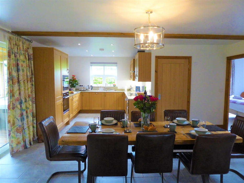 There is a modern dining area and kitchen.  There is access to the veranda from the dining area.  The kitchen has oak cupboards, with built in modern
