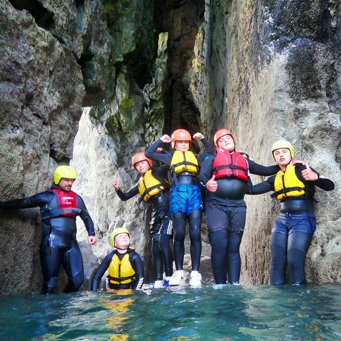 A coasteering group in a sea cave