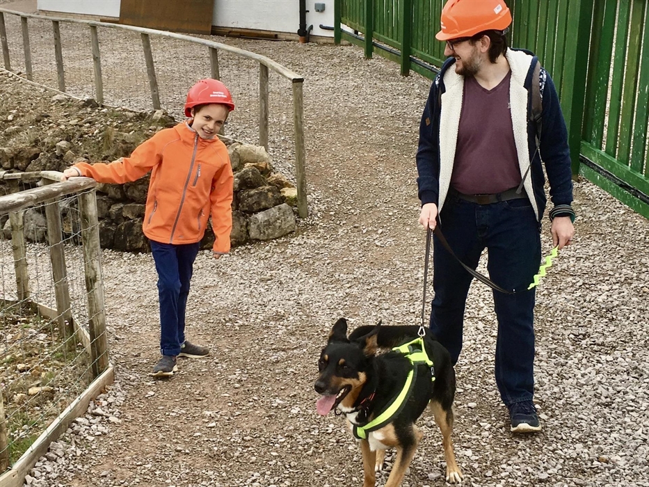 A man, child and a dog walking the surface paths.