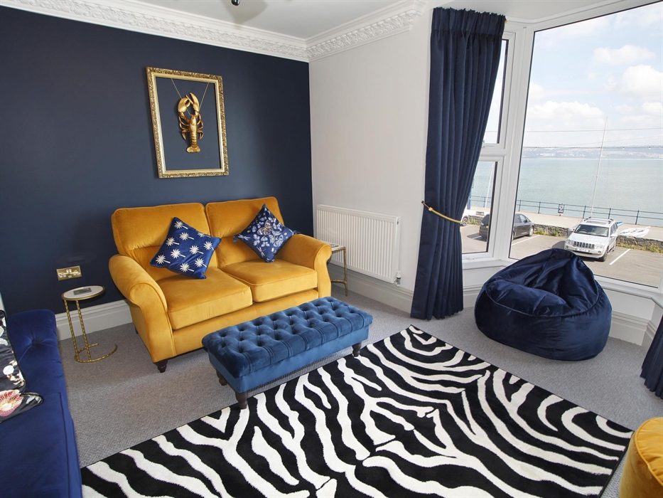 situated on the first floor with sea views. 2 sofas. TV and beanbag