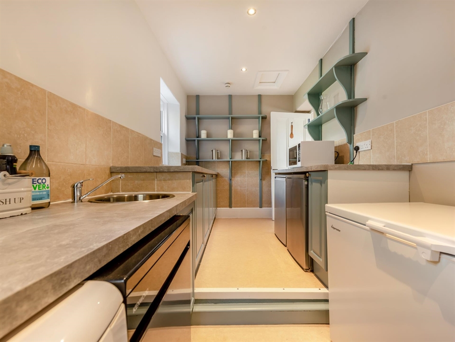 Large pantry area for storage and food preparation, has 2 x dishwashers, chest freezer and 2 undercounter fridges.