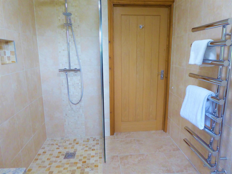 This disabled friendly communal bathroom with shower is situated on the ground floor and provides level access from the ground floor rooms.