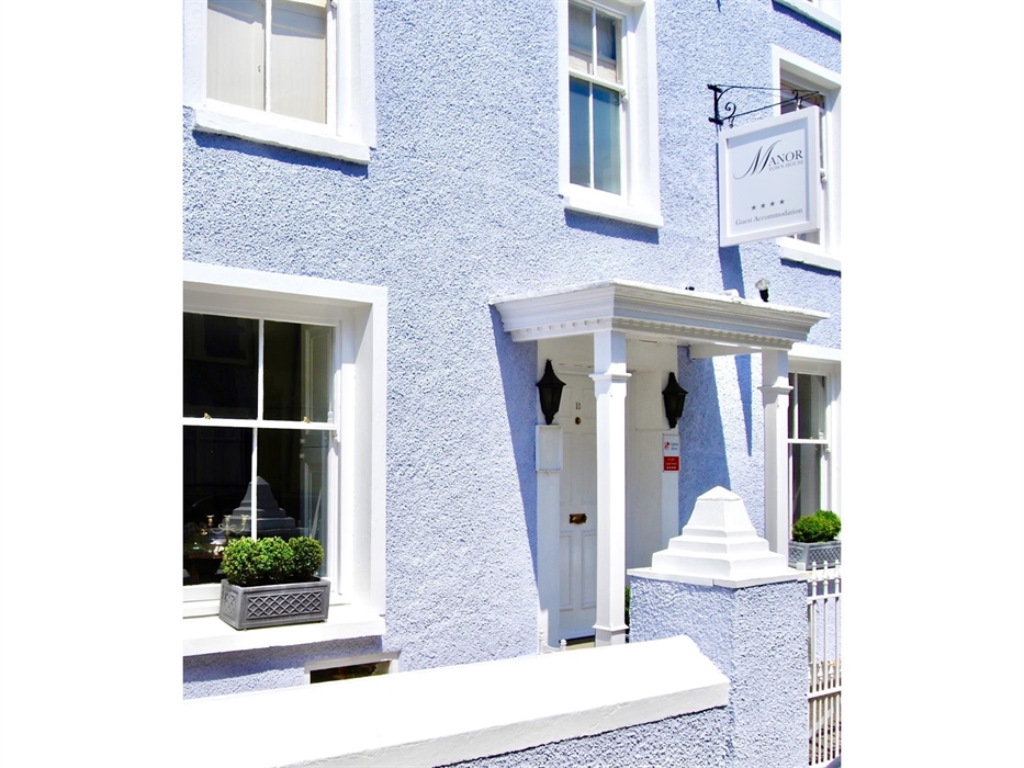 This is the front of the house, painted cornflower blue with white trims. The house is Georgian and 4 stories. The front entrance has a portico and wi