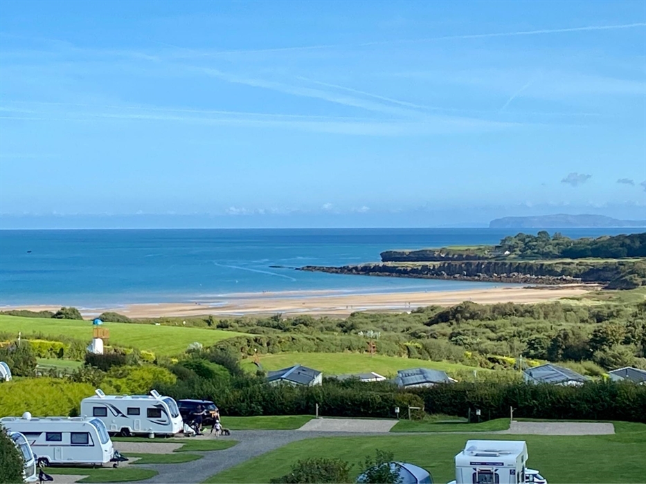 Spacious all-weather serviced pitches for tents, touring caravans, campervans and motorhomes with stunning sea-views of Lligwy Bay on Anglesey.
