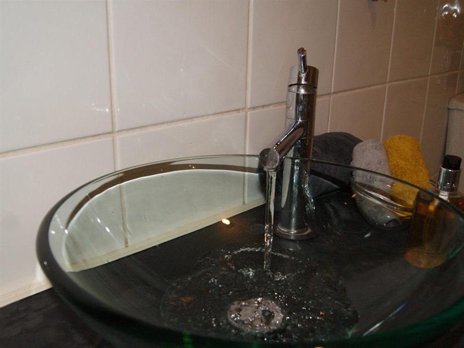 The shower room with toilet adjoins the bedroom has a large shower with overhead spray. Towels, flannels, soap, shower gel, shampoo, shower caps and l