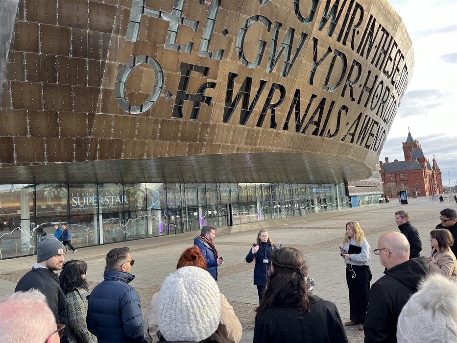 Group of adults standing in front of Wales Millennium Centre